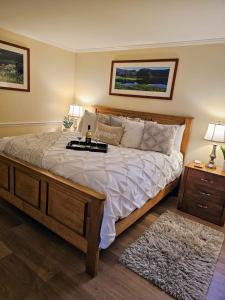 a bedroom with a large bed with white sheets and pillows at Peaceful Oasis steps from Mohegan Sun in Norwich