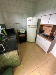 a kitchen with a refrigerator and a counter top at Apto Natureza Verde Manauara II in Manaus +18 photos