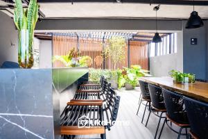 a bar with chairs and plants in a restaurant at Edifício Way Tambaú in Tambaú