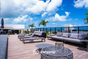 a patio with couches and tables on top of a building at Edifício Way Tambaú in Tambaú