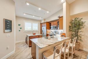 a kitchen with a large island with a counter top at Elegant Naples Condo with Golf View and Community Pool in Naples