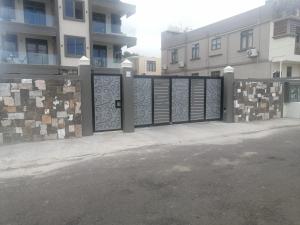 a gate in a fence in front of a building at Mauritius Heights in Flic-en-Flac