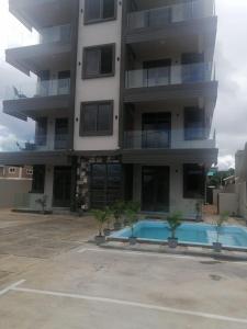 an apartment building with a swimming pool in front of it at Mauritius Heights in Flic-en-Flac