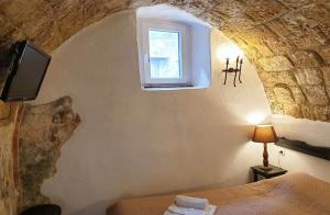 a bedroom with a bed with a tv and a window at Saint Michel Apartments in Rhodes Town