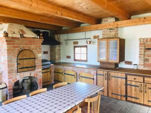 a kitchen with a table and a brick oven at Apartmán Na Sluneční Valtice in Valtice