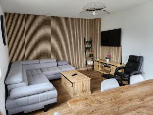 a living room with a couch and a table at Cocon in Domérat