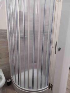 a shower stall in a bathroom with a toilet at Gaeta rHOMEo in Gaeta +10 photos