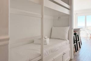 a white bedroom with a bunk bed with a window at Gulf Shores Plantation East 2102 in Gulf Highlands