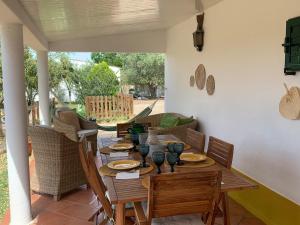 a wooden table and chairs on a patio at Courela da Anta in Vimieiro