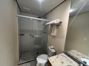 a bathroom with a shower and a toilet and a sink at Hotel Biena Ibirapuera UH407 in Sao Paulo