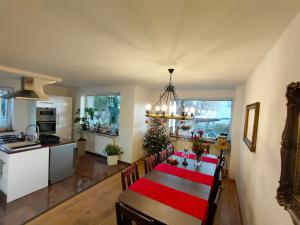a kitchen and dining room with a table with a christmas tree at ViLLA IVET in Gdańsk