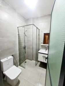 a bathroom with a shower and a toilet and a sink at Elegance Fes Apartments - New city center in Fès