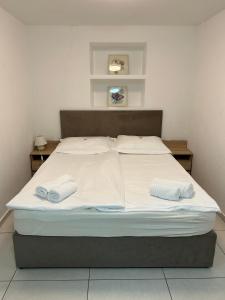 a bed in a room with two towels on it at Hiša Janko Bled in Bled