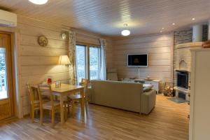 a living room with a couch and a table at Villa Aurora in Jaala