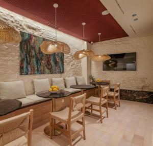 a dining room with two tables and chairs at LIRIUM Casa Patio in Seville