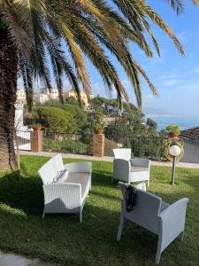 a group of white chairs sitting on the grass at Villa San Vito Amalfi Coast A timeless charm in Vietri sul Mare +50 photos