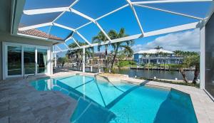 a swimming pool in the middle of a house at Canbiella in Marco Island