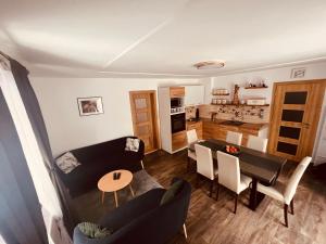 a living room and kitchen with a couch and a table at Chalupa U Franze in Malá Morava