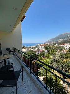 a balcony with a table and a view at Harmony Apartments in Dhërmi