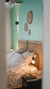 a bedroom with a bed with a table and two plates on the wall at New! Cinéma, Netflix La Douce Evasion in Beaucaire