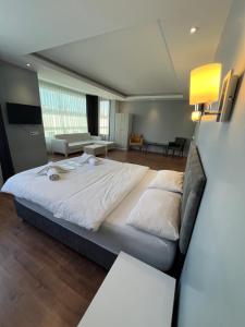 a bedroom with a large bed and a couch at Villasuit in Ankara