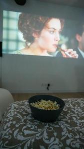 a bowl of granola sitting on a table in front of a tv at New! Cinéma, Netflix La Douce Evasion in Beaucaire