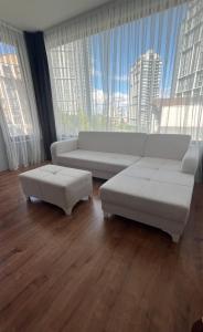 a living room with a white couch and a large window at Villasuit in Ankara
