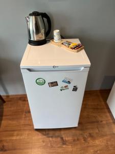 a white refrigerator with a kettle on top of it at Villasuit in Ankara