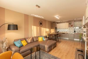 a living room with a couch and a kitchen at Sunset Resort 410 in Fonyód +10 photos