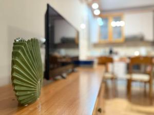a green plant sitting on top of a wooden floor at The Little Blooming House in Agíasma
