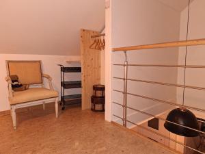 a living room with a chair and a fireplace at Gîte Casa 17 in Coutisse