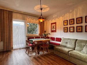 a living room with a couch and a table at Koralm Appartement 7 in Wolfsberg