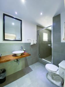 a bathroom with a sink and a shower at Merrils Deluxe at Veraclub in Negril