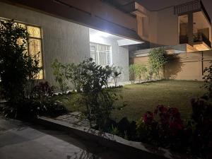 a house with a yard with flowers in front of it at upper portion of a house in Islamabad