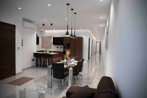 a dining room and kitchen with a table and chairs at Flat 3, nearby Beaches & Countryside, with Terrace in Mġarr