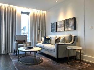 a living room with a couch and a table at Hotel Continental in Oslo