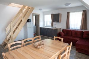 a living room with a wooden table and a couch at Hiša Janko Bled in Bled