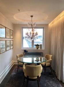 a dining room with a table and chairs and a window at Hotel Continental in Oslo