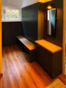 a room with a bench and a mirror and a window at Koralm Appartement 7 in Wolfsberg
