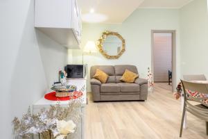 a living room with a couch and a table at "A casa dei Nonni" House near the metro C in Rome