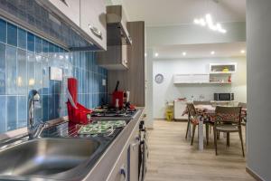 a kitchen with a sink and a stove top oven at "A casa dei Nonni" House near the metro C in Rome