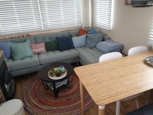 a living room with a couch and a table at Stacaravan Duingras Ameland in Nes