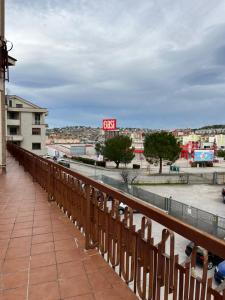 a wooden fence on a balcony with a view of a city at ILBE bed & breakfast in Campobasso