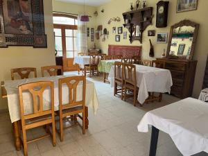 a dining room with tables and chairs and a mirror at Residence Tozeur Almadina in Tozeur