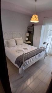 a bedroom with a large bed with white sheets at Christi & Paris Nest in Volos