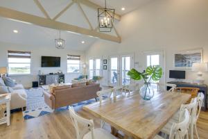 a dining room and living room with a wooden table at Lakefront NOLA Home with Hot Tub and Views! in New Orleans