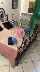 a bedroom with a bed with pink sheets and a piano at House Baby in Elmas