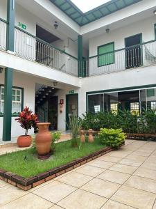 a courtyard of a building with a lot of plants at Pousada Solar dos Guaras in Catas Altas