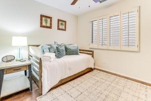 a bedroom with a bed and a desk and a window at Desert Oasis with Outdoor Living in Goodyear! in Liberty +23 photos