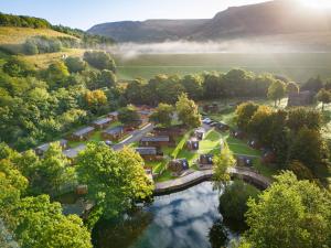 an aerial view of a village with a bridge and a river at Lakeside Pods - pet free in Oldham